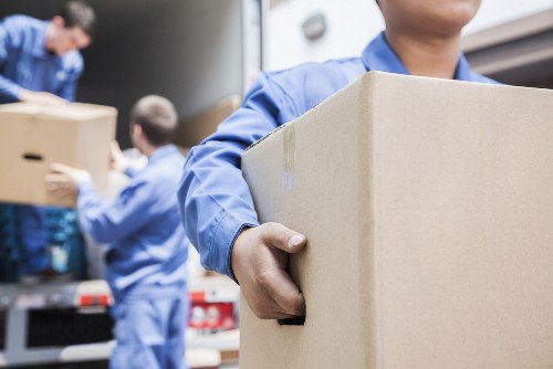 Professional removals team handling boxes in Woolwich