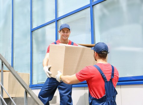 Removal van and moving boxes in a Woolwich street setting
