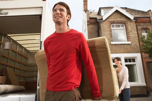 Local Woolwich movers loading furniture into a removal van