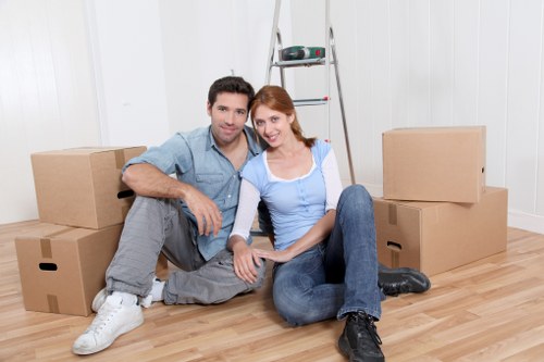 Packed office furniture and boxes prepared for removal in a Woolwich workplace